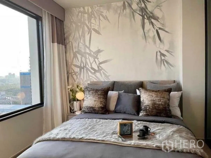 Condominium for rent in Chatuchak, Bangkok - Bedroom with large window, bamboo mural and open city outlook.