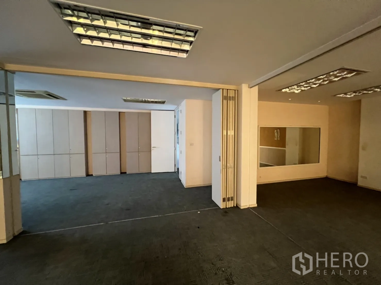 Shophouse for rent or sale in Watthana, Bangkok - Office area with cabinets and an openable partition wall.