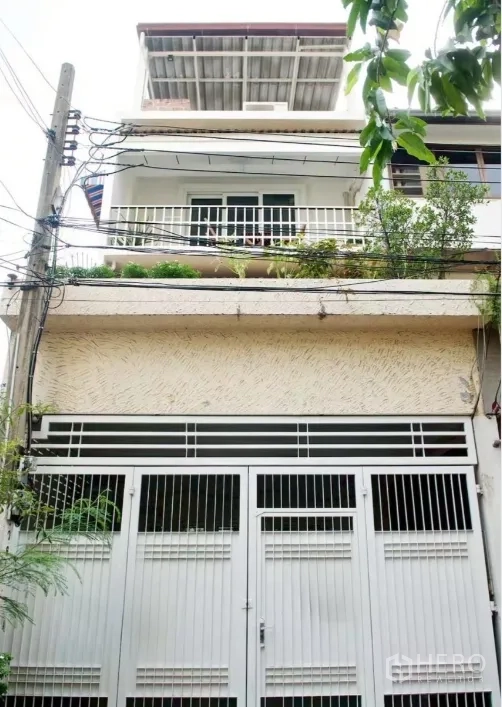 ทาวน์เฮาส์ for rent in Sathon, Bangkok - ด้านหน้าทาวน์เฮ้าส์หลายชั้นพร้อมประตูรั้วเหล็กและระเบียง.