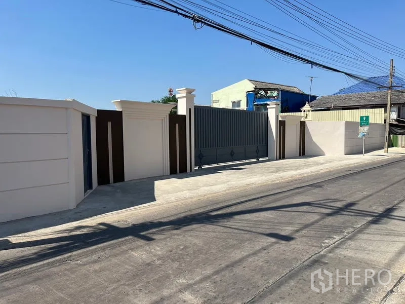 Warehouse for rent or sale - Secure sliding gate and solid boundary wall forming the property frontage.