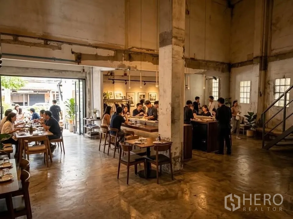 Retail Space for rent in Watthana, Bangkok - Industrial-style interior with wooden tables, central counter, pendant lights, and wide sliding doors.