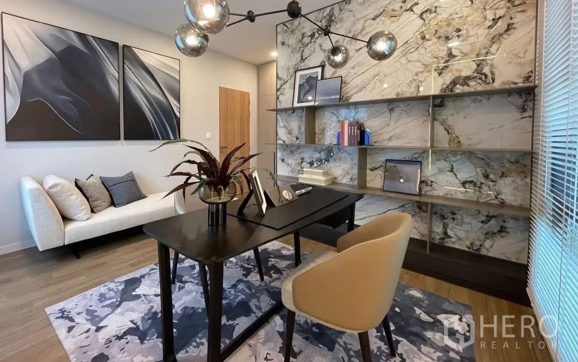 Detached House for rent in Bang Phli, Samut Prakan - Dedicated home office with black desk, sofa, and marble feature wall.