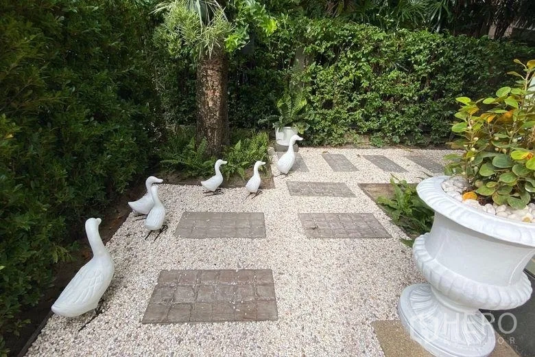 Detached House for rent in Sai Mai, Bangkok - Landscaped pebble garden with stepping stones, tropical plants and white duck ornaments.