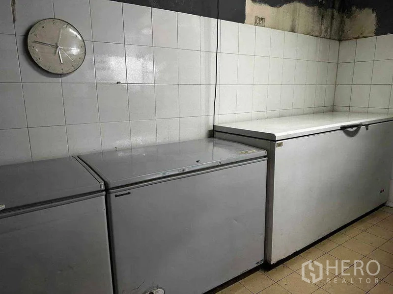 Retail Space for rent in Watthana, Bangkok - Row of chest freezers against a tiled wall in storage room.