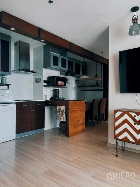 Condominium for rent in Suan Luang, Bangkok - Open-plan kitchen and dining with wood accents and pendant lights