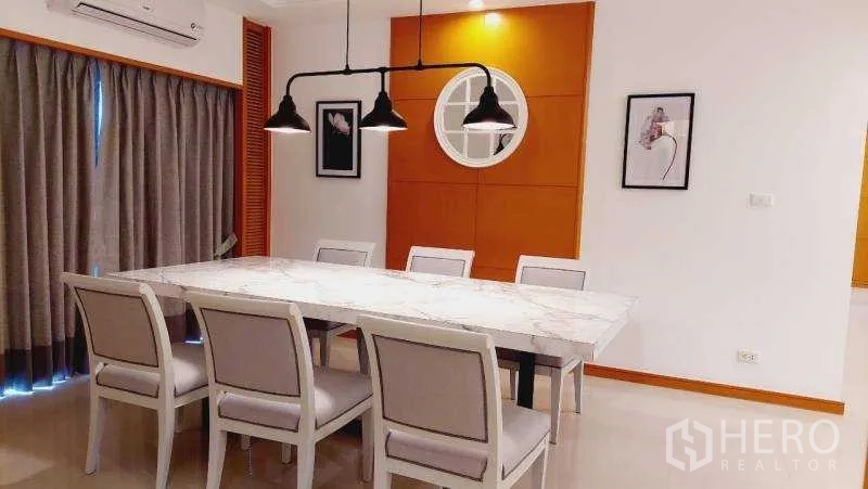 Apartment for rent - Dining room with marble table, six chairs and pendant lights.