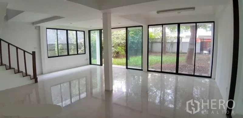 บ้าน ให้เช่าในPrawet, Bangkok - ห้องนั่งเล่นมุมกระจกเต็มบาน เปิดสู่สวนส่วนตัวสีเขียว