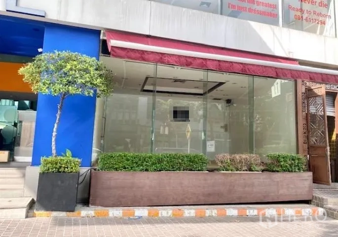 Retail Space for rent in Pathum Wan, Bangkok - Street-level retail storefront with full-height glass, red awning, and planter boxes.