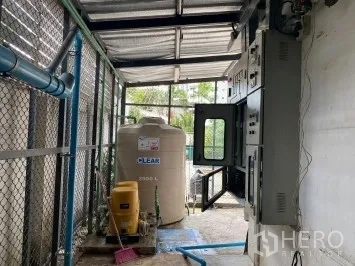Retail Space for rent in Watthana, Bangkok - Outdoor service area with water tank, control panels, and piping under a roof.