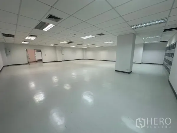 Office Space for rent in Bang Rak, Bangkok - Open workspace with ceiling lighting, air-conditioning and double doors leading to an adjacent service area.