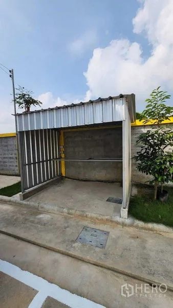 Warehouse for rent in Nong Chok, Bangkok - Small covered utility or guard booth within the fenced compound on a concrete pad.