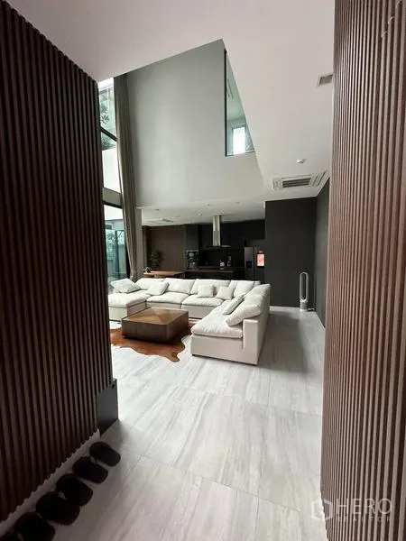 Detached House for rent in Saphan Sung, Bangkok - Entrance hallway with vertical wood slats opening to living room.