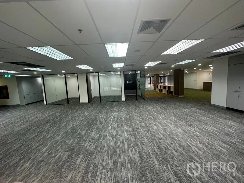 Office Space for rent in Khlong Toei, Bangkok - Central office floor showing multiple glass meeting rooms and bright grid ceiling lighting.