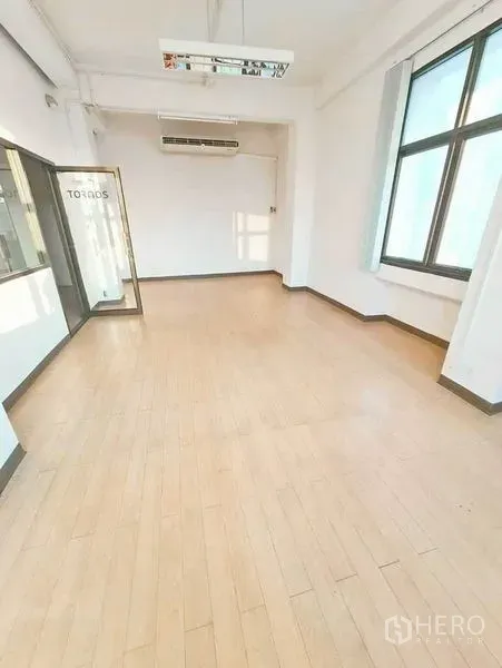 Office Space for rent in Bang Na, Bangkok - Private office room with glass door, big window and wood-style flooring.