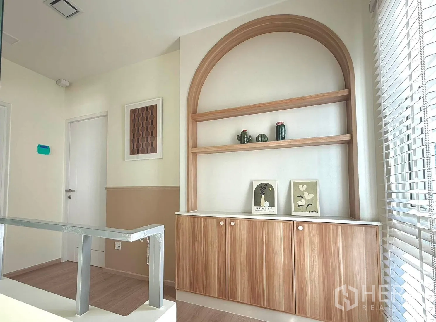 Detached House for rent in Bang Phli, Samut Prakan - Upstairs landing with arched built-in shelving and wood cabinets by a window.