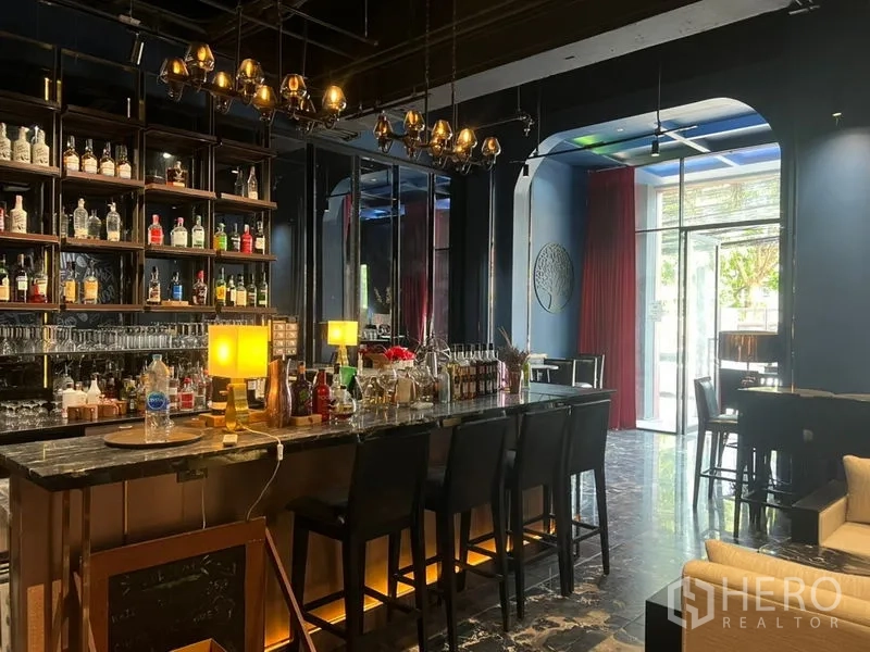 พื้นที่ขายปลีก ให้เช่าในWatthana, Bangkok - พื้นที่ค้าปลีกสไตล์บาร์พร้อมเคาน์เตอร์หินอ่อน ชั้นวางหลังบาร์ไฟสวย โคมแขวน และเก้าอี้สูง ติดประตูกระจกมองเห็นจากถนน