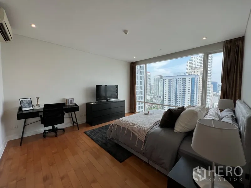 Condominium for rent in Watthana, Bangkok - Spacious master bedroom with desk, TV cabinet, and panoramic city views.