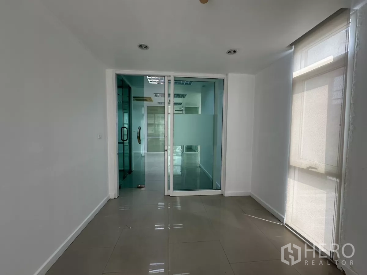 Office Space for rent in Huai Khwang, Bangkok - Small foyer or reception area with frosted sliding glass doors and window shades.