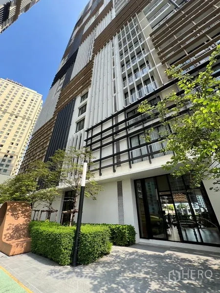 Condominium for sale - Condominium exterior facade featuring patterned screens, vertical lines and greenery.
