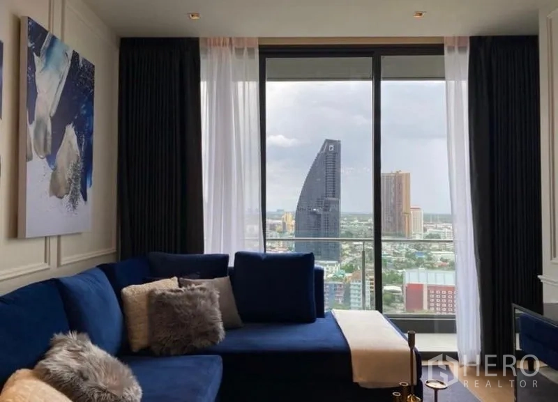 Condominium for rent - Living room window opening to balcony and dramatic skyline featuring a landmark tower.