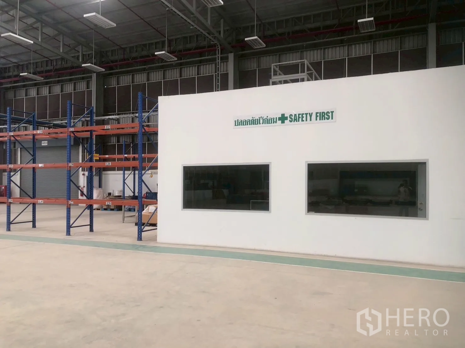 Factory for rent in Pluak Daeng, Rayong - Interior office block with viewing windows beside warehouse shelving and work area.
