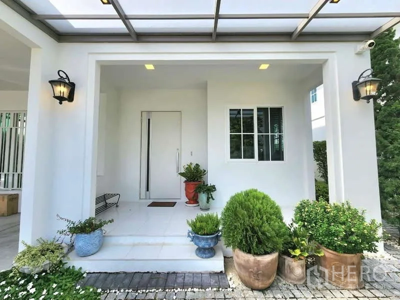Detached House for rent or sale in Bang Phli, Samut Prakan - Covered front porch with potted plants and a white facade.
