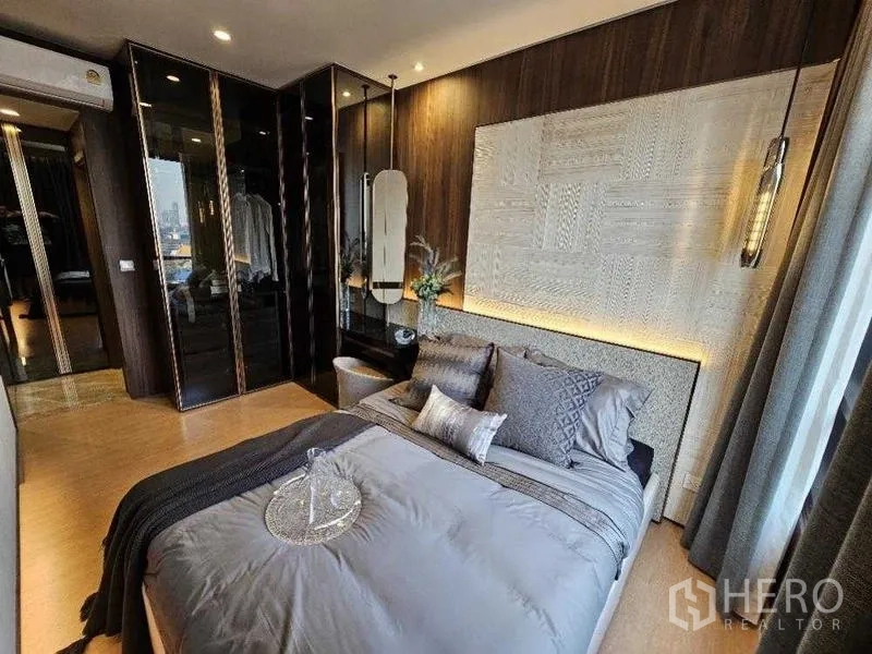 Condominium for rent - Master bedroom with textured headboard, pendant lights and mirrored wardrobe.
