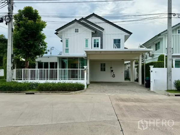 Detached House for rent in Bang Phli, Samut Prakan - Two-storey white detached house with gabled roof, gated front yard and double carport.