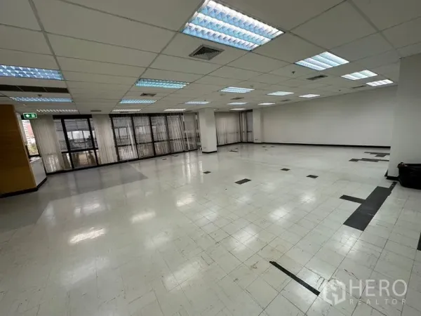 办公空间 出租在Khlong Toei, Bangkok - 宽敞工作区，柱体、吊顶灯和整面玻璃配百叶帘