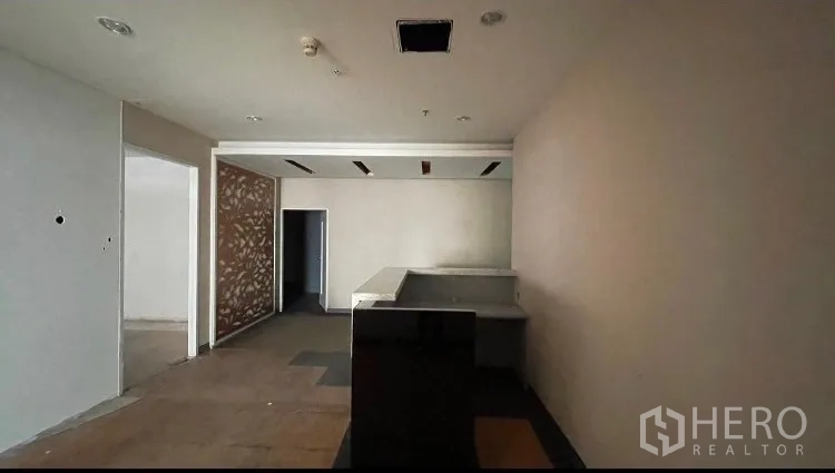 Office Space for rent or sale - Lobby-style entry with dark stone reception counter and doorway to side rooms.