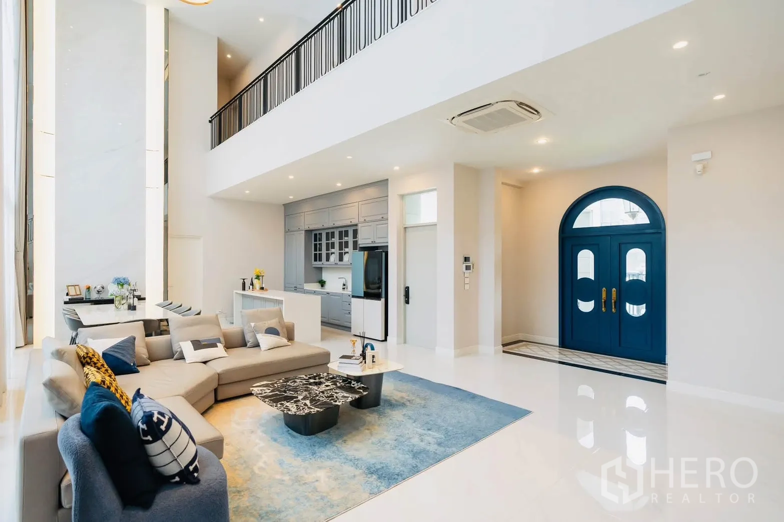 Detached House for rent or sale in Bang Kapi, Bangkok - Grand entry with arched blue double doors opening to a spacious living room.