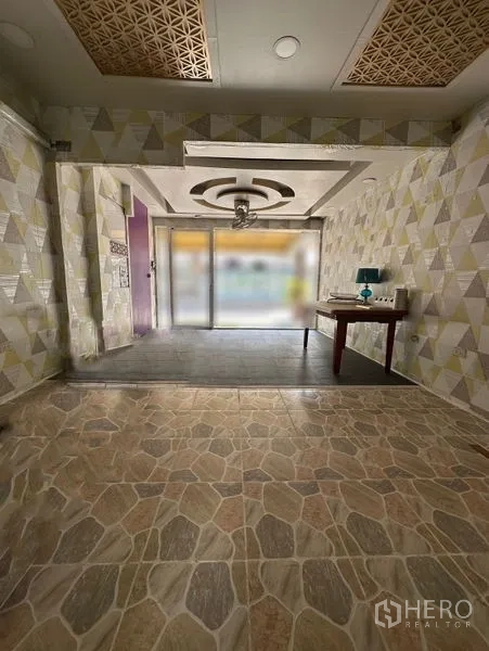 Retail Space for rent in Watthana, Bangkok - Open-plan 30 sqm shop floor with raised display area, geometric wallpaper, and natural light.