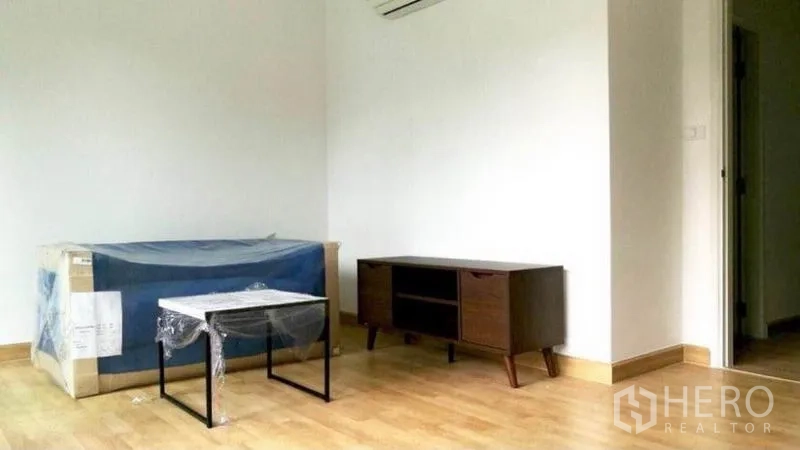 联排别墅 出租在Wang Thonglang, Bangkok - 楼上起居区，木地板、电视柜与空调，部分家具到位