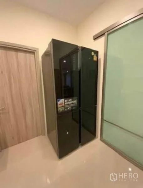 Detached House for rent - Large black double-door refrigerator in the pantry.
