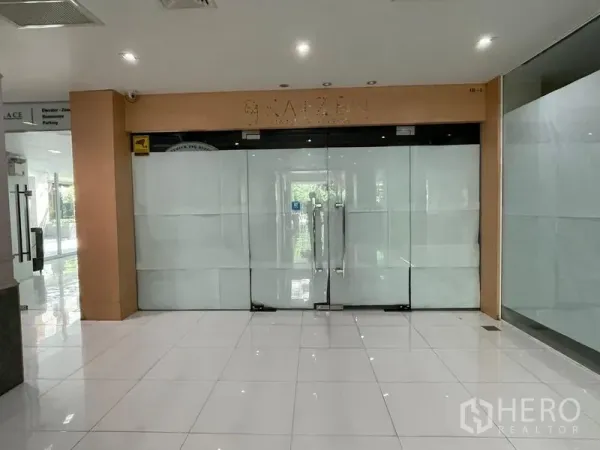 Office Space for rent in Ratchathewi, Bangkok - Glass double-door entrance to a commercial unit set on polished white tile flooring.