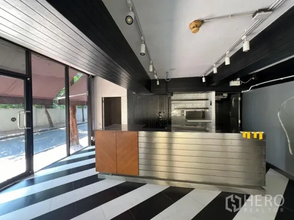Retail Space for rent in Bang Rak, Bangkok - Interior retail space with black-and-white striped floor and stainless service counter.