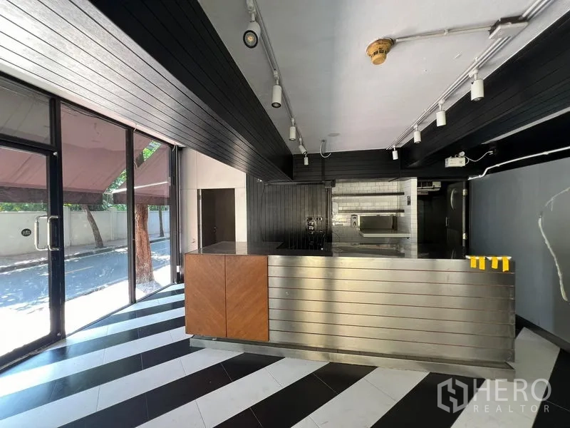 Retail Space for rent in Bang Rak, Bangkok - Interior retail space with black-and-white striped floor and stainless service counter.