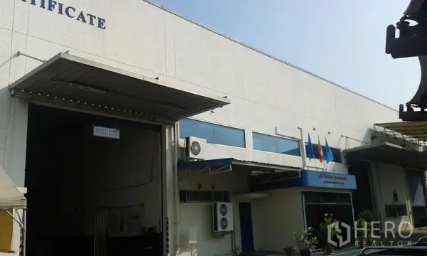 Factory for rent in Uthai, Phra Nakhon Si Ayutthaya - Close view of loading dock and office frontage with air-conditioning units and flag poles.