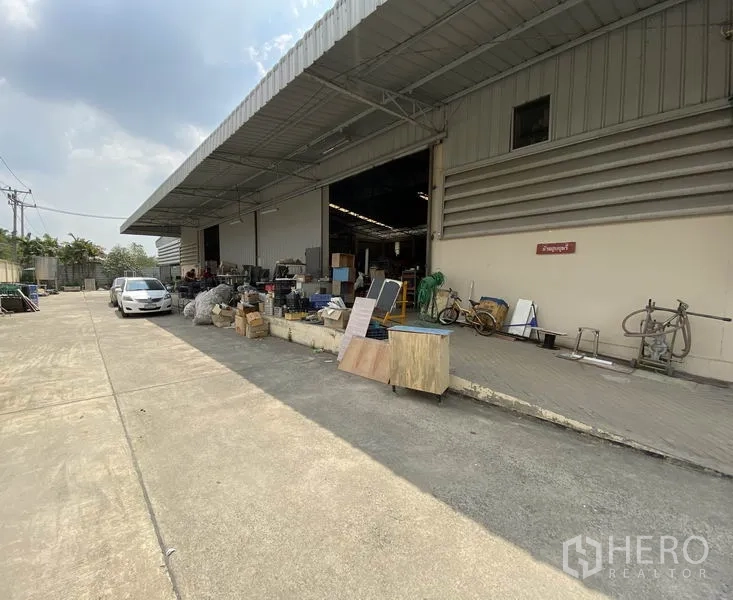 工厂 出售在Khlong Luang, Pathum Thani - 仓库正面，卷闸门开启的装卸月台与宽车道。