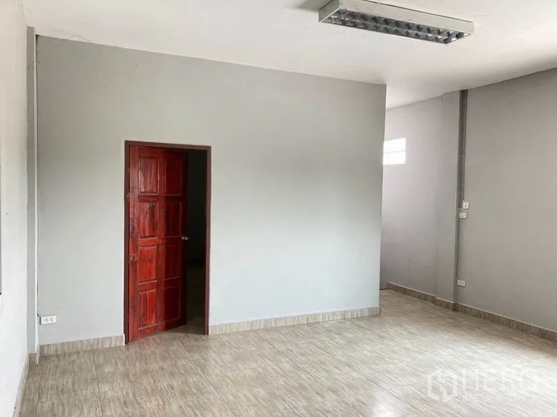 Warehouse for rent in Bang Phli, Samut Prakan - Private office or meeting room with grey walls, tiled floor and a wooden door.