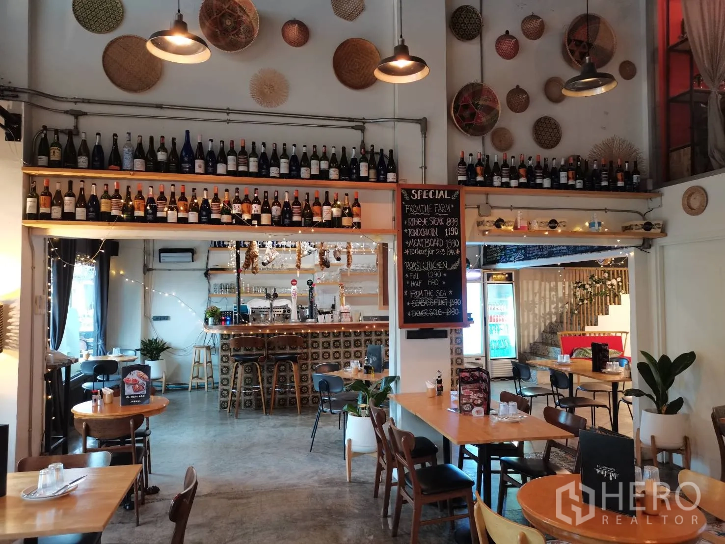 Retail Space for rent in Watthana, Bangkok - Restaurant hall facing the bar with wine-bottle shelving and specials board.
