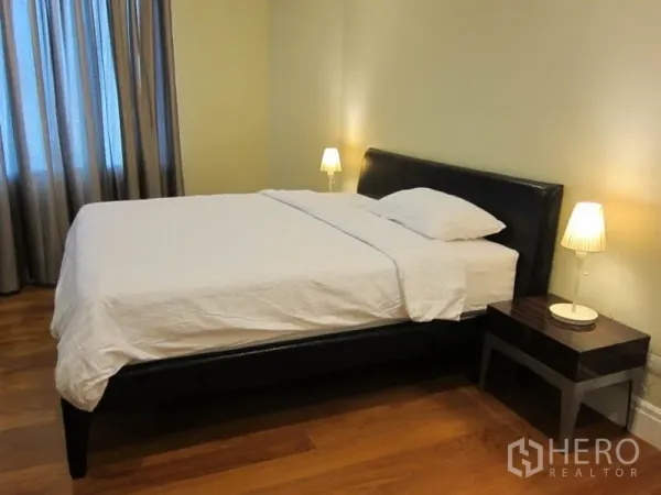 Condominium for rent in Khlong Toei, Bangkok - Another view of the serene bedroom with upholstered headboard and matching nightstands.