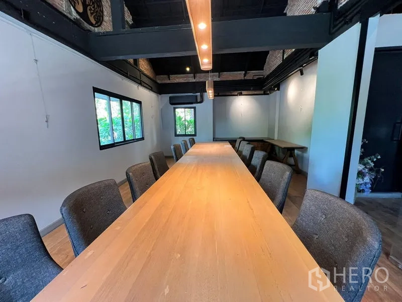 Retail Space for rent in Bangkok - Private meeting or dining room with a long wooden table and linear pendant light.