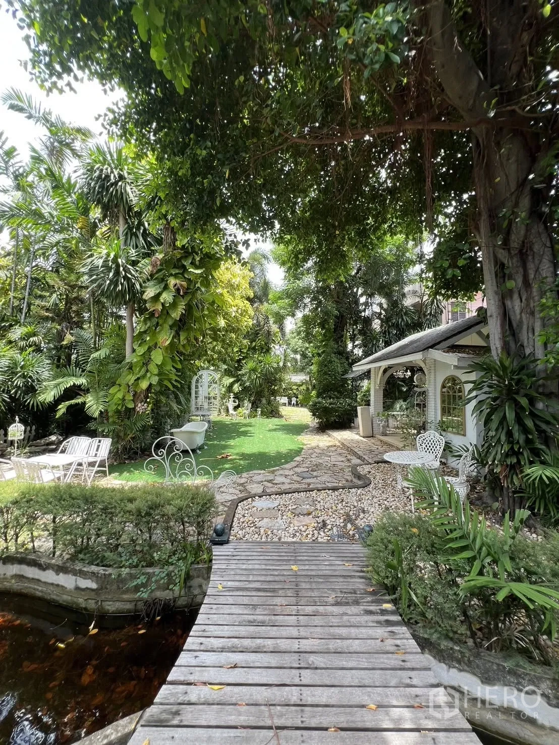 Detached House for rent in Phra Khanong, Bangkok - Wooden footbridge over a small pond leading through the garden.