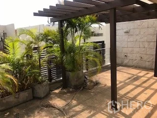 Townhouse for rent or sale in Yan Nawa, Bangkok - Sunny rooftop deck with wooden pergola and tropical plants.