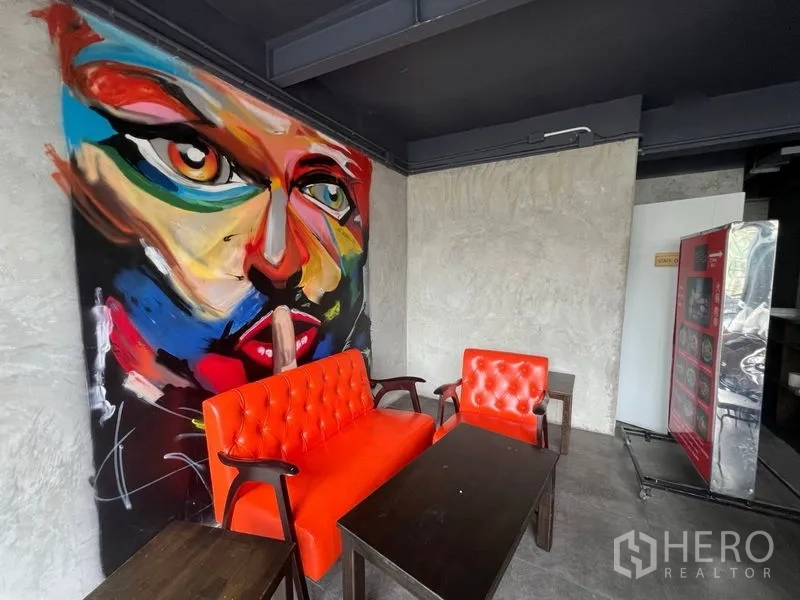 Retail Space for rent in Watthana, Bangkok - Cozy corner seating with orange sofa and chairs beside an abstract mural.