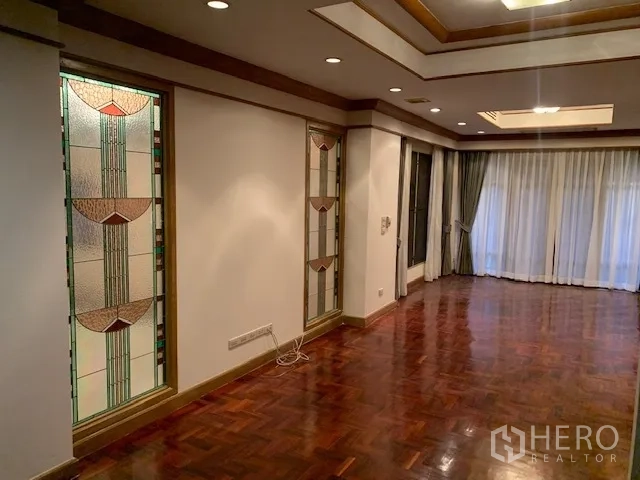 独立式住宅 出租在Khan Na Yao, Bangkok - 走廊墙面装饰彩色玻璃，托盘式吊顶与落地窗帘。