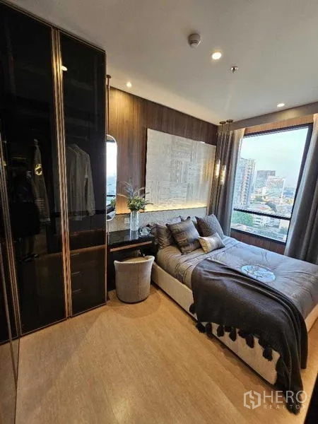 Condominium for rent - Bedroom corner with large window framing Bangkok skyline.