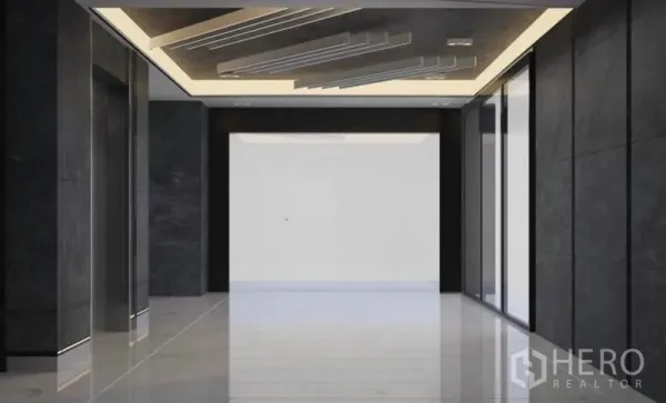 Office Space for rent in Lat Krabang, Bangkok - Modern lobby with black marble walls, backlit ceiling details, and a reflective tiled floor.
