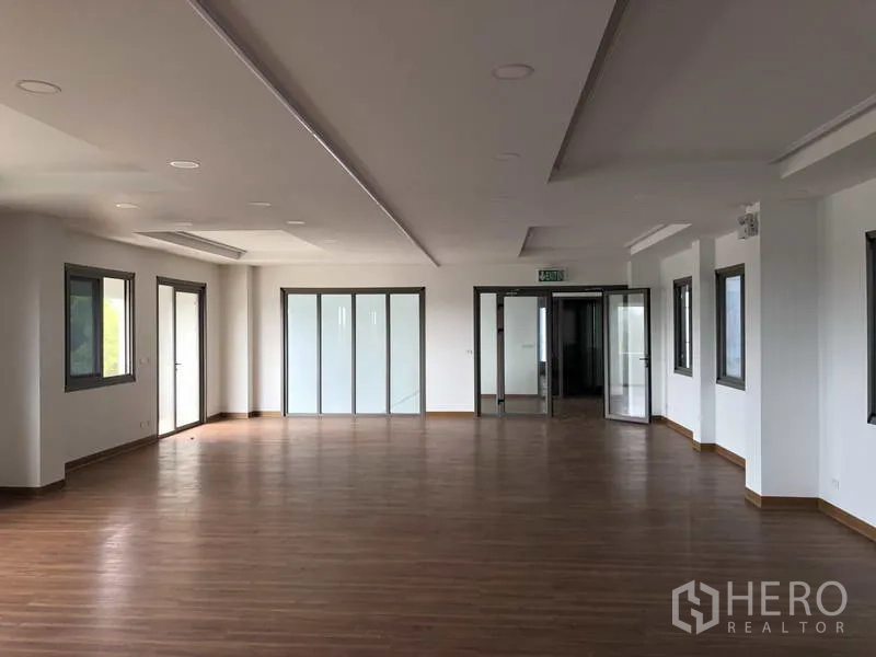 Factory for rent or sale in Samut Prakan - Office area with glass partitions and double doors leading to meeting rooms.